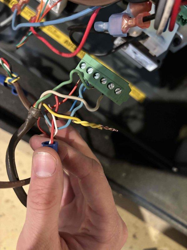 Responded to no-cool condition on 12-year-old Goodman air conditioning system affecting entire home. Upon inspection, identified faulty wiring connections at the unit's terminal block causing system failure to start. Repaired and secured all electrical connections including red, blue, yellow, and ground wires to terminal block, ensuring proper voltage delivery to compressor and fan circuits. Verified all wire terminations were tight and properly seated. Tested system startup and confirmed unit now operating normally with proper cooling restored to home.