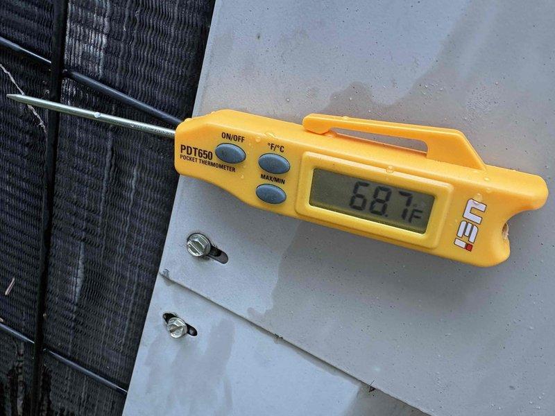# Cooling Performance Diagnostic - Goodman AC Unit

Responded to service call for air conditioning system blowing cool but not cold air. Unit is a 31-year-old Goodman system with condenser manufactured in 2021.

Upon arrival, performed comprehensive temperature diagnostics using calibrated digital thermometer. Measured supply air temperature at indoor unit registers, recording 73°F outlet temperature. Proceeded to outdoor condenser unit to assess refrigeration cycle performance.

Conducted temperature analysis at condenser coil, measuring coil surface temperature of 88.1°F. Visual inspection of condenser coil revealed unit operational but not achieving optimal cooling capacity. Examined heat exchanger fins and refrigerant lines for proper heat transfer operation.

Temperature differential between supply air and condenser coil indicates system experiencing reduced cooling efficiency consistent with age of equipment and potential refrigerant charge issues or compressor performance degrad