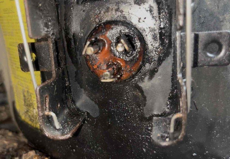 # AC Repair - Capacitor Replacement

Responded to service call for air conditioning unit not cooling to desired temperature. Upon inspection, found 23-year-old system with failed dual run capacitor exhibiting severe corrosion, oxidation, and physical deterioration. Capacitor showed extensive weathering with compromised insulation, corroded terminal connections, and damaged wire leads. Heavy rust and mineral deposits present on contactor assembly and surrounding electrical components indicated prolonged exposure to environmental conditions and end of component service life.

Removed failed capacitor and replaced with new unit meeting manufacturer specifications. Cleaned corroded electrical connections and contactor terminals. Verified proper electrical connections and system operation. Unit tested successfully with compressor and condenser fan motor operating at normal parameters. System now cooling properly to thermostat setpoint.