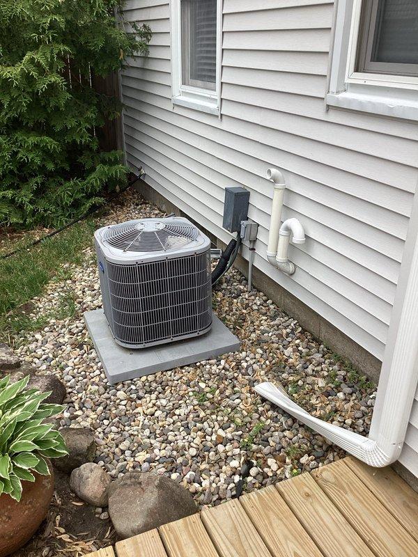 # No Cool Service Call - 17-Year-Old Carrier AC Unit

Responded to a no cool condition on a 17-year-old Carrier air conditioning system. Upon arrival, performed visual inspection of outdoor condenser unit, which appeared to be in fair physical condition with signs of age-related wear on the fan grille and housing. Unit was properly installed on concrete pad with adequate clearance and landscaping. Conducted diagnostic testing to identify cause of system failure. Documented equipment condition and installation setup with photographs for service records. Customer notified of findings and system status upon completion of diagnostic evaluation.