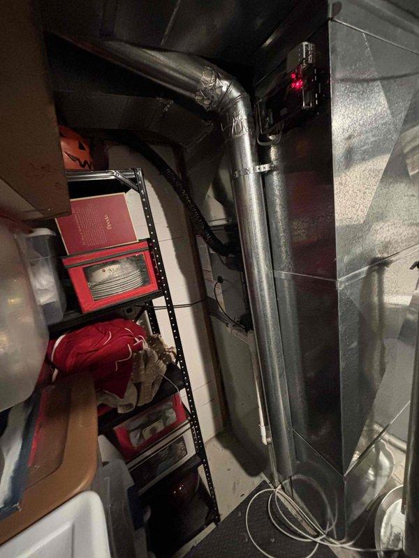 Completed full HVAC system replacement including furnace and air conditioning unit in basement utility room. Installed new gray metal furnace with proper electrical connections and ventilation, along with coordinating air conditioning equipment. System integration included existing Aprilaire humidifier with metallic ductwork connections, ensured all components properly configured and operational with standard residential water heater remaining in place.