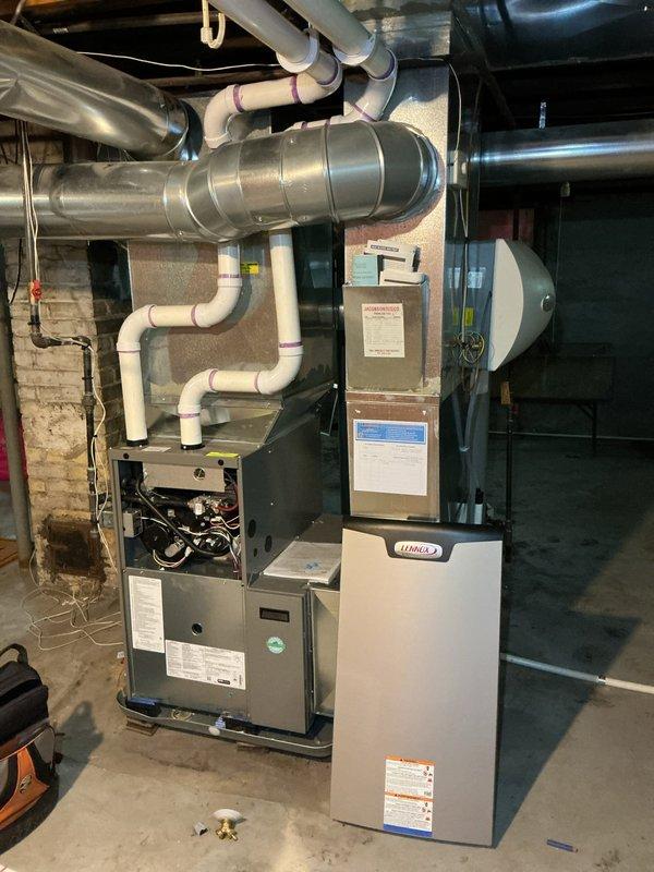 Completed rental inspection of unoccupied property, accessing premises via side door lockbox. Inspected and documented basement mechanical systems including Lennox brand furnace and water heater unit. Photographed HVAC equipment, ductwork configuration, PVC plumbing lines, and overall mechanical room infrastructure to verify operational condition and system layout for rental property assessment.