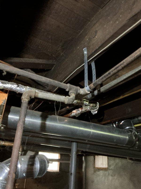Completed rental inspection of unoccupied property, accessing premises via side door lockbox. Inspected and documented basement mechanical systems including Lennox brand furnace and water heater unit. Photographed HVAC equipment, ductwork configuration, PVC plumbing lines, and overall mechanical room infrastructure to verify operational condition and system layout for rental property assessment.