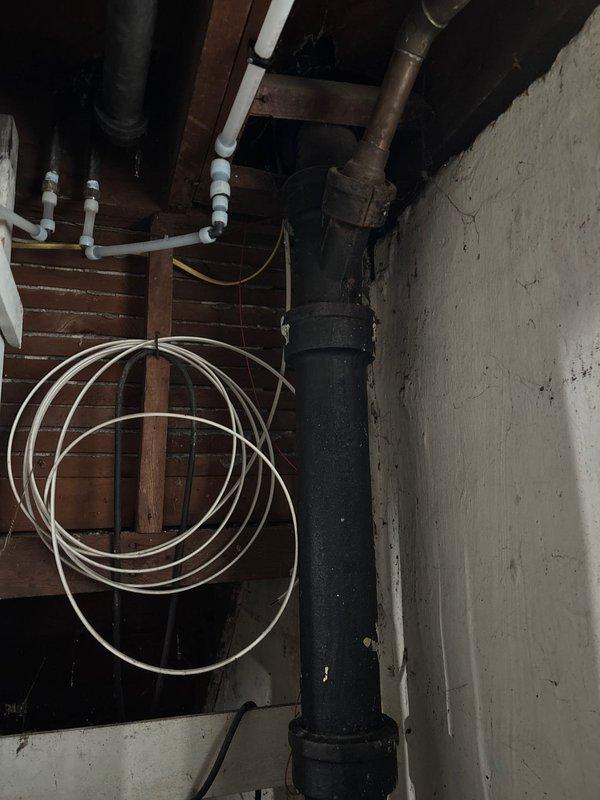 Installed new water supply line to refrigerator location, routing PVC piping along basement ceiling joists with proper support brackets. Completed drain line modifications for kitchen sink, connecting to existing cast iron waste stack. All connections tested and verified leak-free upon completion.