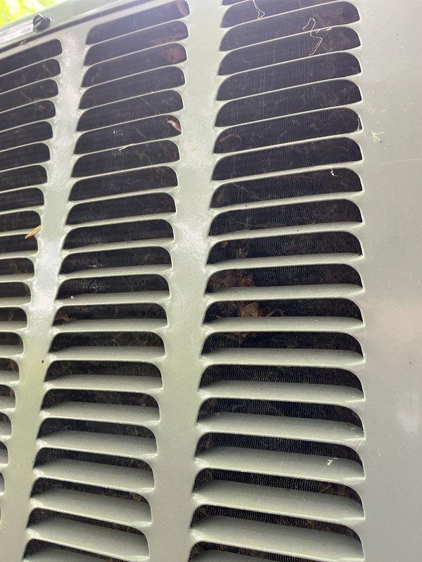Completed annual cooling maintenance on 2013 system. Inspected evaporator coil and return air grille, both showing normal dust accumulation for a four-year-old unit. Documented current condition of HVAC components with photos showing coil fins properly aligned and grille louvers intact with typical wear patterns.