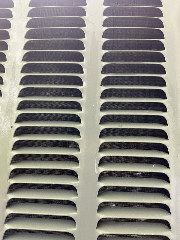Completed annual cooling maintenance on 2013 system. Inspected evaporator coil and return air grille, both showing normal dust accumulation for a four-year-old unit. Documented current condition of HVAC components with photos showing coil fins properly aligned and grille louvers intact with typical wear patterns.