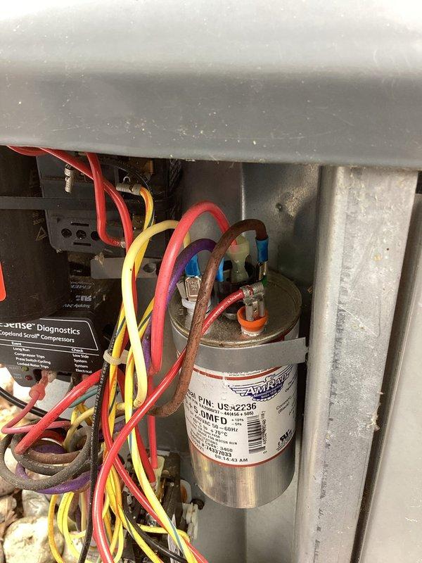 Responded to no cooling complaint on 6-year-old EnergiAir system with warranty through July 2029. Upon inspection, found severely corroded wire connection at capacitor terminal causing system failure. Replaced damaged capacitor and corroded wiring, verified all electrical connections, and restored system to proper cooling operation.