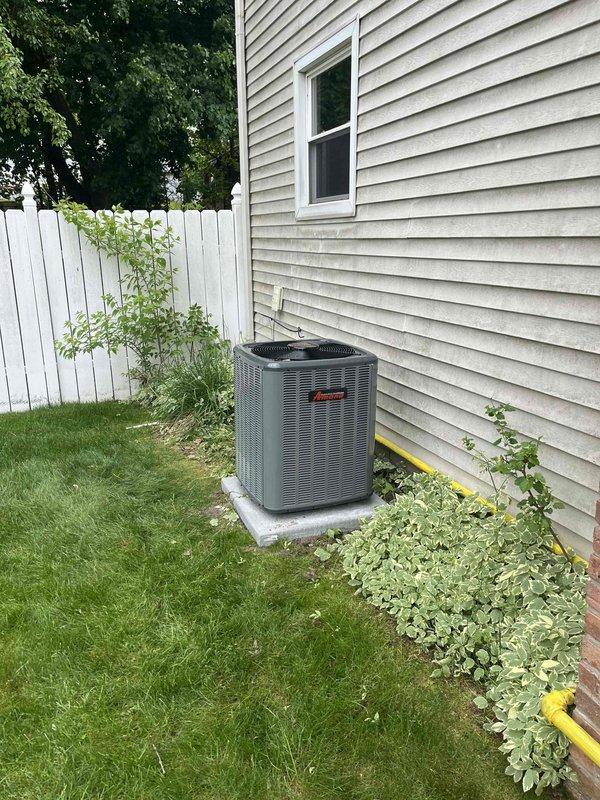 Completed full HVAC system installation including new Amana air conditioning condenser unit positioned on concrete pad at exterior foundation with proper clearances maintained, and new residential forced-air furnace installed in basement utility area. All refrigerant lines, condensate drainage, and PVC venting systems connected per manufacturer specifications, with copper linesets properly insulated and secured. System commissioned, tested for proper operation, and all safety labels verified in place.