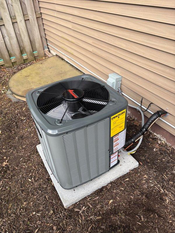 Completed add-on air conditioning system installation at residential property. Installed new outdoor condensing unit on concrete pad adjacent to house exterior, secured refrigerant lines to siding with proper routing, and mounted electrical disconnect box. Charged system with refrigerant per manufacturer specifications, documenting factory charge of 534 oz and field charge of 8 oz for total system charge of 61.4 oz. Verified all refrigerant connections, service ports, and line insulation properly installed. System tested and operational.