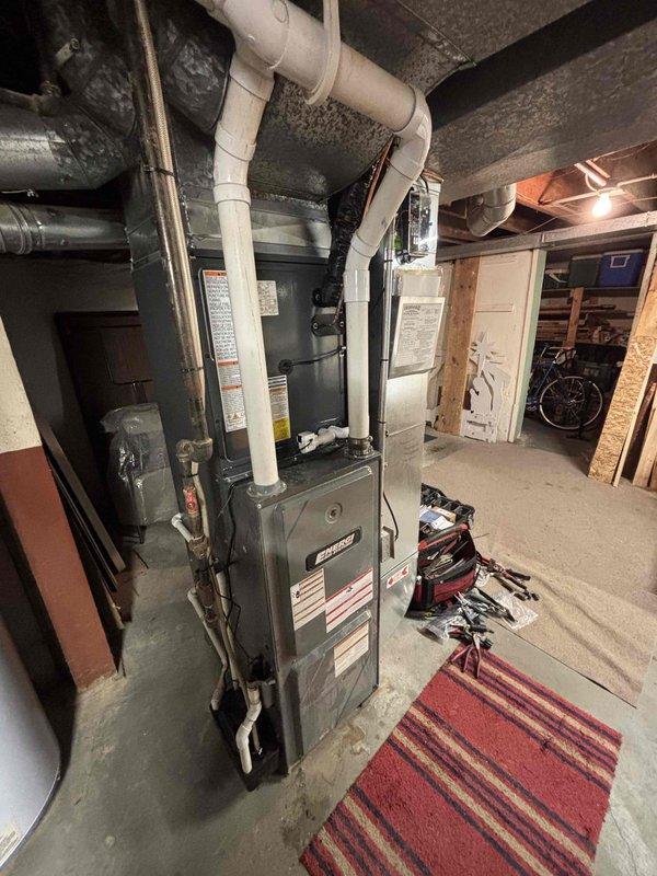 Completed add-on air conditioning installation to existing forced-air heating system. Integrated new AC coil with existing gas furnace, installed refrigerant lines, and configured condensate drainage using PVC piping. System tested and verified operational with all components properly labeled and secured per manufacturer specifications.