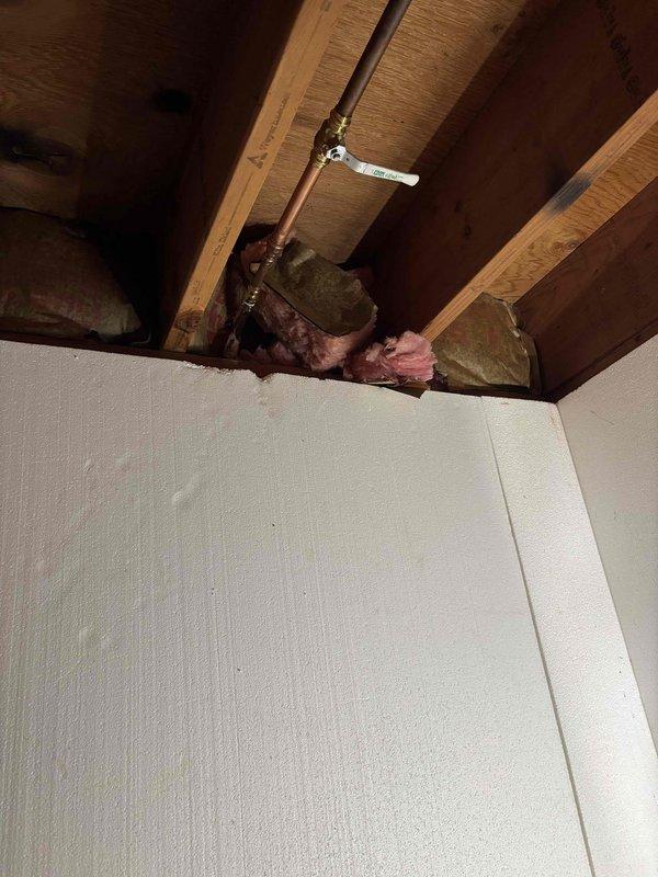 Responded to plumbing leak issue where exterior hose spigot was leaking into crawl space. Accessed crawl space and located corroded copper pipe supply line feeding the outdoor faucet with no existing shutoff valve. Installed new brass shutoff valve on the water supply line to provide isolation capability for the exterior spigot, preventing future leaks from entering the crawl space and allowing for easier maintenance and winterization of the outdoor faucet.