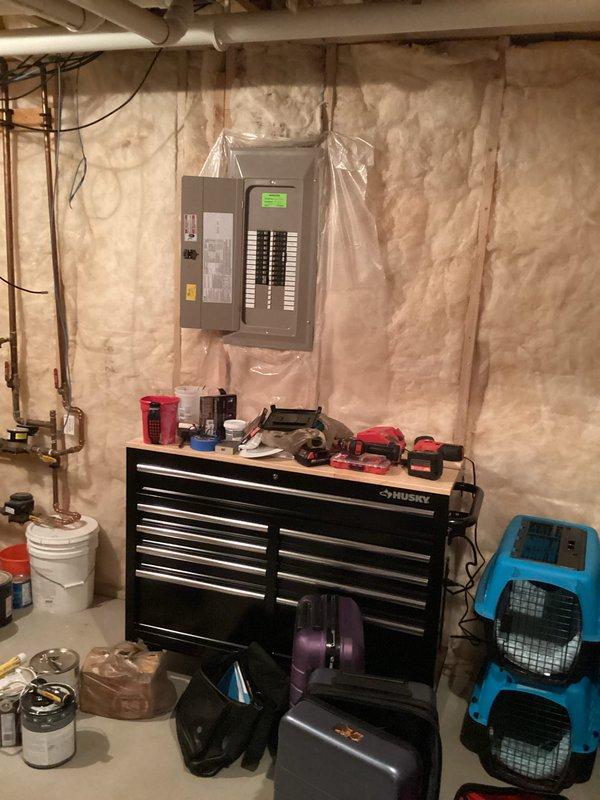Conducted site assessment for standby generator installation at residential property. Evaluated existing electrical panel configuration in basement utility area, documented current electrical infrastructure including main service panel with digital display and circuit breaker arrangement. Assessed available space and electrical connections required for generator integration with home's power system. Photographed electrical panel location, surrounding utility area conditions, and workspace to develop comprehensive installation estimate for automatic transfer switch and generator system.