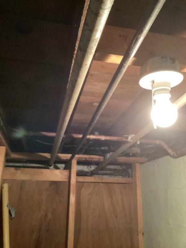 Responded to service call for gas line evaluation and quote preparation. Inspected existing gas piping system in basement area, identifying sections of galvanized pipe requiring assessment for potential replacement. Documented current installation configuration including pipe routing along ceiling joists and connections to mechanical equipment. Photographed existing gas line components, pipe materials, and accessibility conditions to support accurate quote development for gas line modification or replacement work.