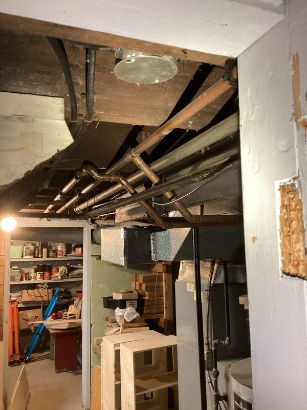 Responded to service call for gas line evaluation and quote preparation. Inspected existing gas piping system in basement area, identifying sections of galvanized pipe requiring assessment for potential replacement. Documented current installation configuration including pipe routing along ceiling joists and connections to mechanical equipment. Photographed existing gas line components, pipe materials, and accessibility conditions to support accurate quote development for gas line modification or replacement work.
