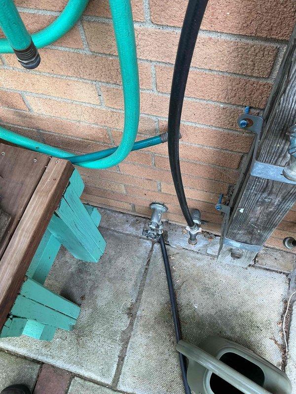Replaced exterior faucet assembly mounted on brick wall in outdoor utility area. Installed new valve fixture with proper connections to existing water supply lines, ensuring secure mounting and leak-free operation for improved functionality.