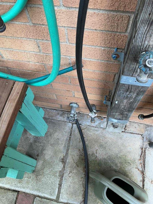 Replaced exterior faucet assembly mounted on brick wall in outdoor utility area. Installed new valve fixture with proper connections to existing water supply lines, ensuring secure mounting and leak-free operation for improved functionality.