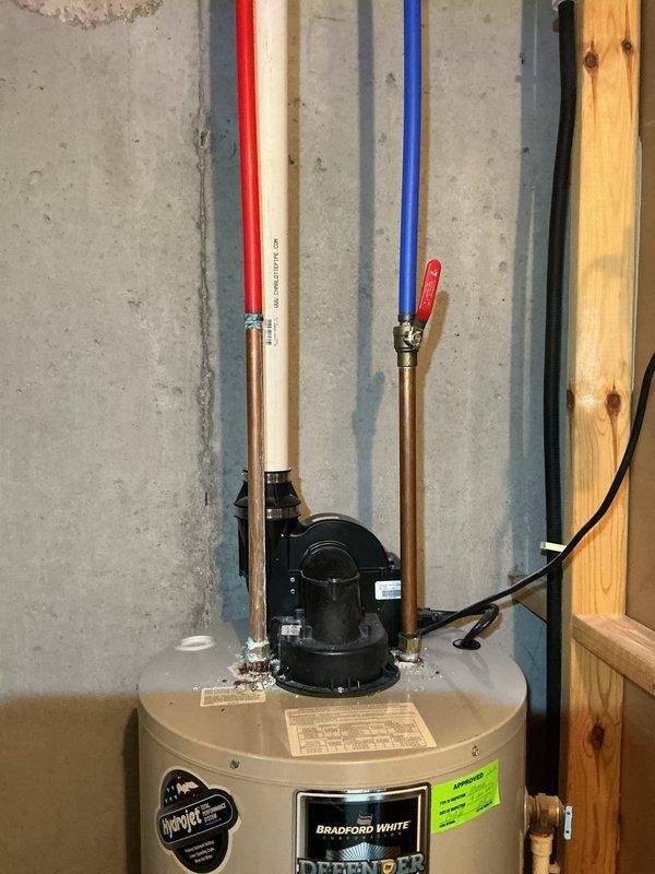 Inspected 5-year-old Bradford White water heater with significant corrosion present on top of unit. Documented existing conditions with photographs showing corroded connections and piping assembly including copper lines, PEX hot and cold water connections, PVC vent pipe, and shut-off valves. Customer was notified of findings and provided with visual documentation of the corrosion issue for their records.