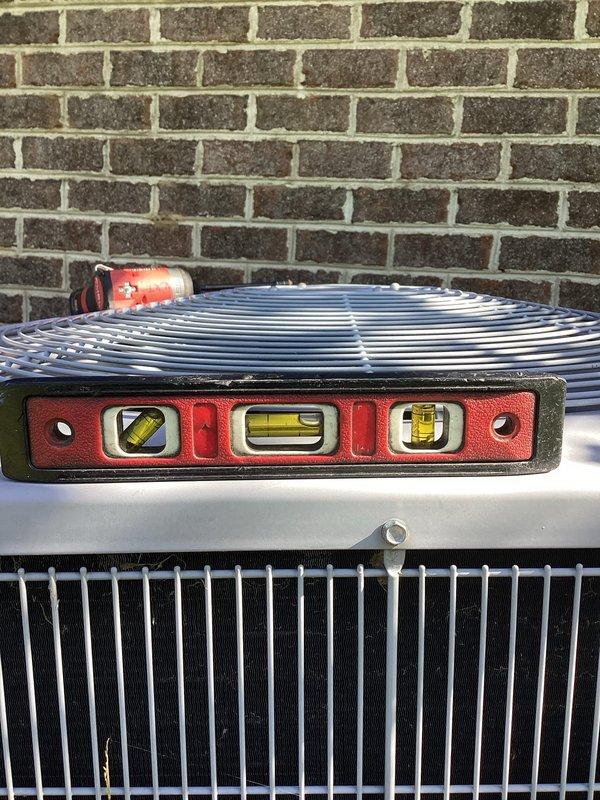 Completed annual cooling maintenance on 12-year-old Carrier air conditioning system. Performed comprehensive tune-up including inspection of outdoor condensing unit, verified proper leveling of equipment using precision tools, and documented unit condition with photos. All components operating within normal parameters at time of service.