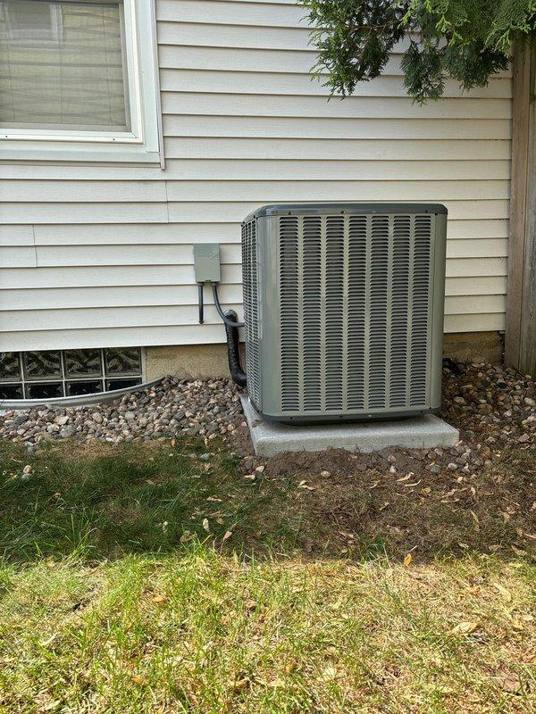Completed full air conditioning system replacement including outdoor condenser unit and indoor air handler components. Installed new Carrier equipment on existing concrete pad with proper electrical disconnect, refrigerant line sets, and condensate drainage. Connected system to existing gas furnace in basement mechanical room, ensuring proper ductwork integration and airflow configuration.