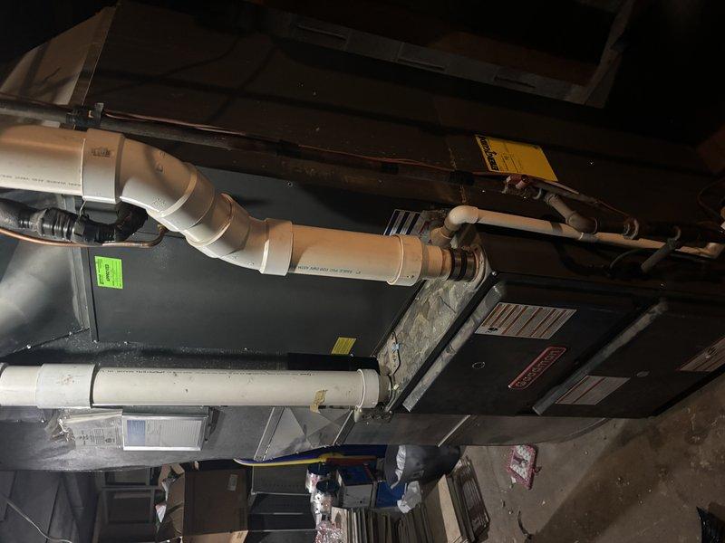 Completed comprehensive AC Super Tune-up on residential air handler system. Inspected evaporator coil fins showing good condition with uniform spacing and proper airflow capacity, verified condensate drainage lines and PVC piping connections secure and functioning properly, and documented all manufacturer specifications and equipment labels present on unit. System operating efficiently with all components in good working order.