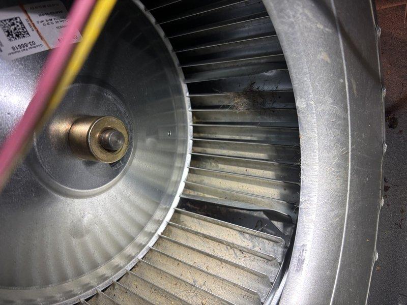 # NC-No Cool Service Completed

Responded to no cooling complaint following storm event. Upon arrival, performed system diagnostics on HVAC unit. Inspection revealed blower assembly with significant dust and debris accumulation on squirrel cage fan blades, affecting airflow efficiency. Examined control board and electrical connections in air handler compartment. All wiring connections, capacitors, and control module found secure with no visible storm damage. System operational after thorough inspection. Documented equipment condition with photographs showing blower wheel contamination and control board assembly. Unit restored to normal cooling operation.
