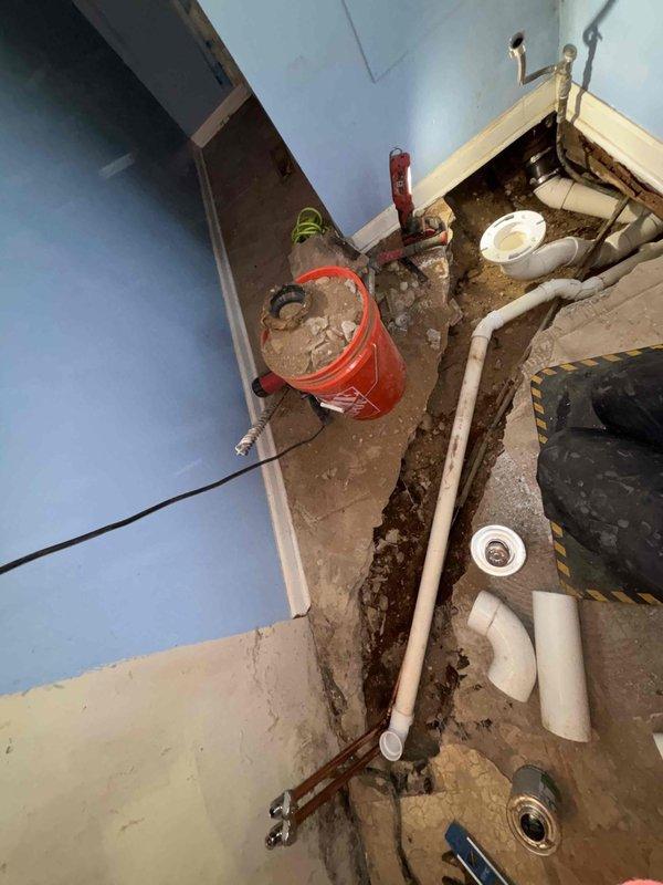 # Drain and Waste Repipe Completed

Performed complete drain and waste system repipe in residential bathroom over two-day period. Excavated bathroom floor to access existing drain lines, removing flooring material to expose concrete substrate and underlying plumbing infrastructure. Demolished and removed deteriorated drain and waste piping system.

Installed new PVC drain and waste piping throughout bathroom, including proper pitch and venting per code requirements. Routed new drain lines for toilet, bathtub, and lavatory fixtures. Connected all new waste lines to main building drain. Pressure tested all new piping to verify system integrity and proper drainage function.

Coordinated fixture rough-in locations to match existing bathroom layout. All work performed in accordance with applicable plumbing codes and industry standards. System ready for floor restoration and fixture installation.