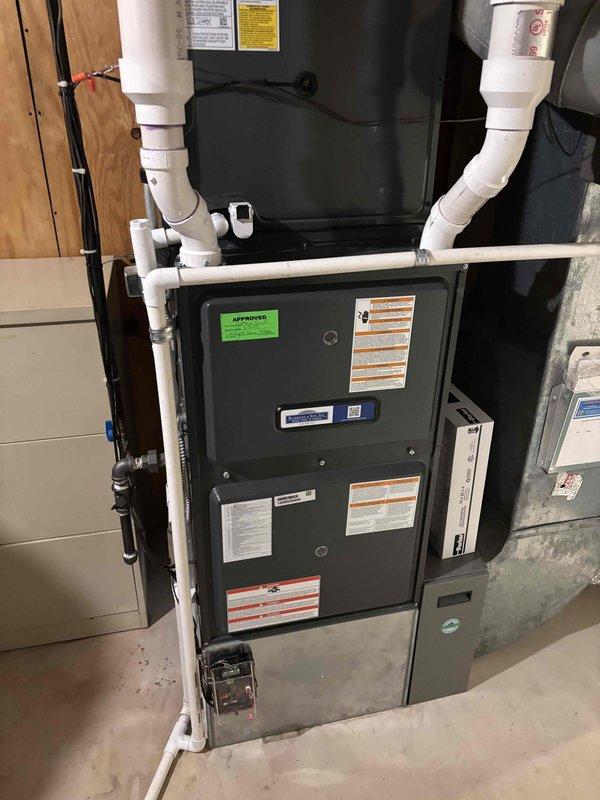 Successfully completed full HVAC system replacement in basement utility area. Installed new furnace unit with proper clearances and ventilation, including complete PVC condensate drain and vent piping configuration with multiple elbows and joints. Connected flexible silver ductwork to new air handler, ensuring proper airflow distribution throughout the structure. All installations meet manufacturer specifications and building code requirements, with organized piping layout and professional finish work completed.