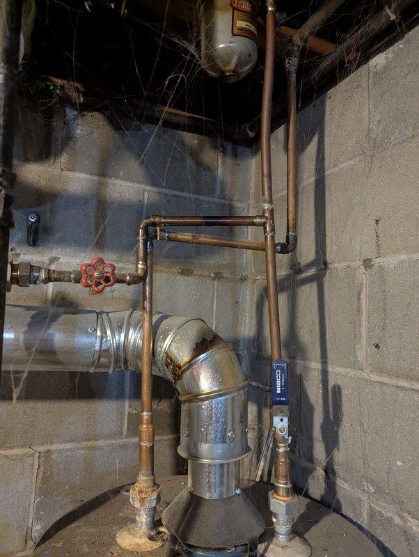 Responded to no cooling complaint on 31-year-old Bryant system. Upon arrival, performed diagnostic evaluation of air conditioning unit and associated components. Documented existing equipment conditions including basement utility area plumbing, water heater installation, and surrounding infrastructure with photographic evidence for service records.