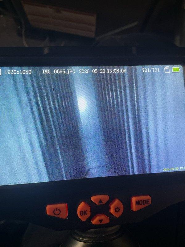 Responded to no cooling complaint on residential air conditioning system. Upon arrival, confirmed filter had been changed and disconnects were operational per customer report. Performed visual inspection of rooftop unit exterior and accessed internal components for diagnostic evaluation. Utilized borescope camera to inspect evaporator coil condition and discovered significant dirt and debris accumulation on coil fins, restricting airflow and reducing heat transfer efficiency. The contaminated coil was identified as primary cause of inadequate cooling performance. Documented coil condition with inspection camera showing heavily soiled fins requiring professional cleaning to restore proper system operation and cooling capacity.