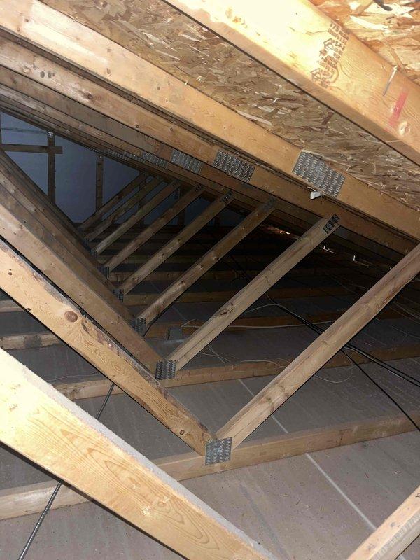 Conducted on-site assessment for whole-house backup generator installation to address recurring power outages during storm events. Evaluated existing natural gas line accessibility and capacity for generator connection. Inspected attic space and structural framing to determine optimal routing for electrical conduit and gas line extensions. Documented current electrical panel configuration and available space for automatic transfer switch installation. Photographed attic framing, floor joists, and potential penetration points for conduit runs. Assessed exterior locations for generator placement considering clearance requirements, gas line proximity, and code compliance. Verified existing 2023 HVAC system compatibility with backup power requirements. Provided detailed estimate for complete standby generator system including unit specifications, automatic transfer switch, gas line connection, electrical integration, and installation labor.