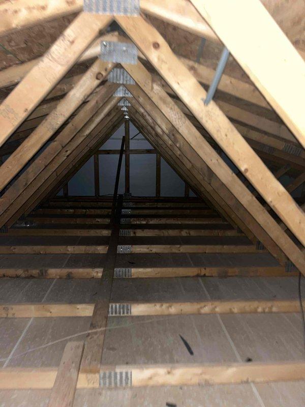 Conducted on-site assessment for whole-house backup generator installation to address recurring power outages during storm events. Evaluated existing natural gas line accessibility and capacity for generator connection. Inspected attic space and structural framing to determine optimal routing for electrical conduit and gas line extensions. Documented current electrical panel configuration and available space for automatic transfer switch installation. Photographed attic framing, floor joists, and potential penetration points for conduit runs. Assessed exterior locations for generator placement considering clearance requirements, gas line proximity, and code compliance. Verified existing 2023 HVAC system compatibility with backup power requirements. Provided detailed estimate for complete standby generator system including unit specifications, automatic transfer switch, gas line connection, electrical integration, and installation labor.