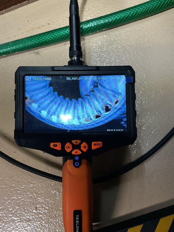 Responded to service call for 14-year-old Goodman furnace experiencing flame sensor issues and exhaust odor concerns. Upon arrival, inspected flame sensor which had previously tripped and was reset by occupant. Found residue buildup on flame sensor requiring cleaning. Conducted thorough inspection of heat exchanger using borescope camera to check for potential cracks or deterioration that could cause combustion byproducts to enter living spaces. Examined exhaust vent system and combustion chamber for proper operation and signs of incomplete combustion. Addressed concerns regarding unusual exhaust odor detected in bedroom area. Cleaned flame sensor, verified proper furnace operation, and documented equipment condition with photos. System operational at time of departure.