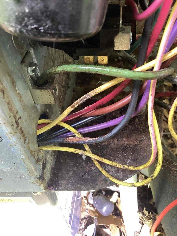 # Cooling System Diagnostic and Repair

Responded to service call for air conditioning system blowing warm air and failing to maintain set temperature. Upon arrival, performed comprehensive system diagnostic to identify root cause of cooling failure.

Accessed indoor air handler unit and inspected electrical components, including capacitor, contactor, and associated wiring connections. Found significant dust and debris accumulation throughout the unit interior, which can impede proper system operation and heat transfer. Noted visible corrosion and oxidation on metal housing and mounting hardware, indicating age and environmental exposure of the equipment.

Conducted electrical testing of capacitor using multimeter to verify proper microfarad ratings and ensure component functionality. Inspected all wire connections at capacitor terminals and contactor for signs of looseness, overheating, or deterioration. Verified integrity of multi-colored control and power wiring throughout the syste