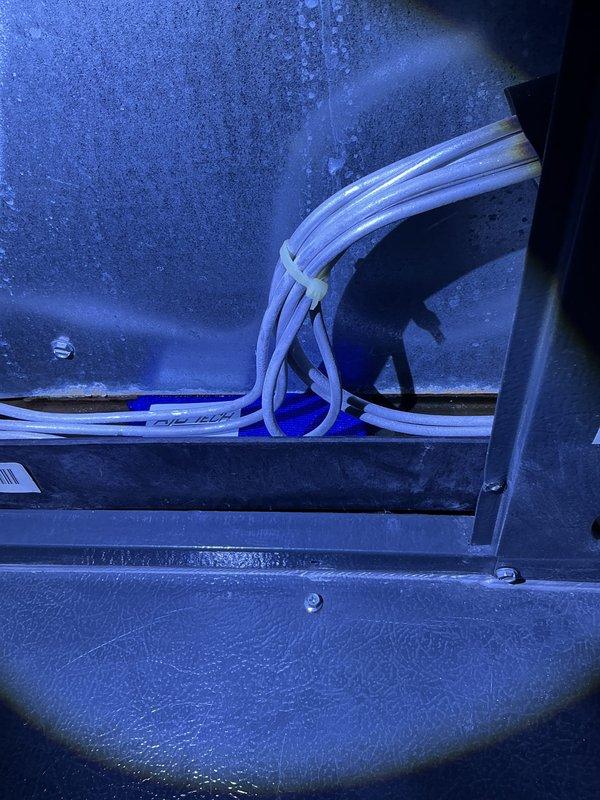 Completed annual cooling maintenance on 12-year-old EnergiAir system with 2019 condenser. Replaced heavily soiled air filter with new filter, documenting significant dust and debris accumulation on original filter. Inspected evaporator coil and discovered excessive frost buildup on coil surfaces and interior cabinet walls, indicating potential airflow restriction or refrigerant issue. Documented refrigerant line routing and frost conditions. System requires follow-up to address freezing condition and verify proper airflow and refrigerant charge levels.