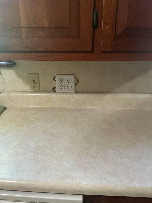 Completed installation of additional electrical outlets in residential property. Installed quadplex receptacle in kitchen area above countertop with matching wall plate, and added electrical outlet in room with wood paneling near window area. All outlets properly wired, tested for functionality, and secured with appropriate cover plates matching existing finishes.