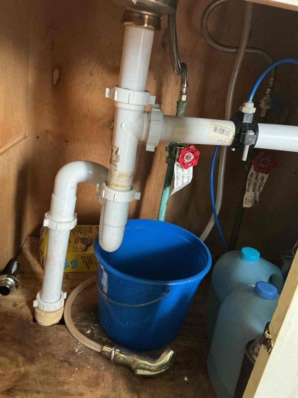 Responded to a clogged drain issue in a 52-year-old residence that had been ongoing for four days. Upon inspection, located the affected drain beneath the kitchen sink where a P-trap and filtration system were installed. Cleared the blockage in the drain line, verified proper flow and drainage, and confirmed all plumbing connections were secure and functioning correctly.