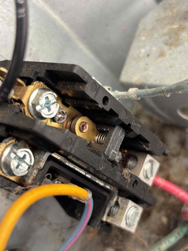 Completed annual cooling maintenance on 13-year-old air conditioning system. Performed comprehensive inspection of electrical components, including contactor assembly and terminal connections. Documented existing conditions showing normal age-related wear, minor oxidation on brass terminals, and dust accumulation within electrical enclosure. All wire connections verified secure, system operational and ready for cooling season.