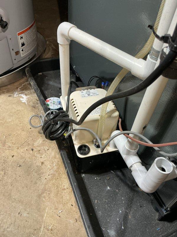 Completed comprehensive annual cooling system maintenance and inspection under 3-year ENERGIAIR warranty agreement. Performed standard AC tune-up procedures including system diagnostics, refrigerant level verification, electrical component testing, and condensate drainage system inspection. Documented mechanical room equipment configuration including condensate pump assembly with PVC discharge piping and drainage pan installation. Inspected return air ventilation grille showing moderate dust and debris accumulation in louvered sections; noted standard maintenance cleaning recommended to maintain optimal airflow efficiency. All HVAC components operating within manufacturer specifications at time of service completion.