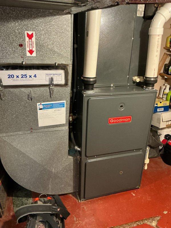 Completed annual cooling maintenance on 15-year-old Goodman HVAC system. Inspected air handler with 20x25x4 MERV 13 filter, verified proper airflow direction, checked all electrical connections, and tested system operation. Documented equipment condition with photographs showing furnace, air handler, and associated plumbing components all functioning within normal parameters.