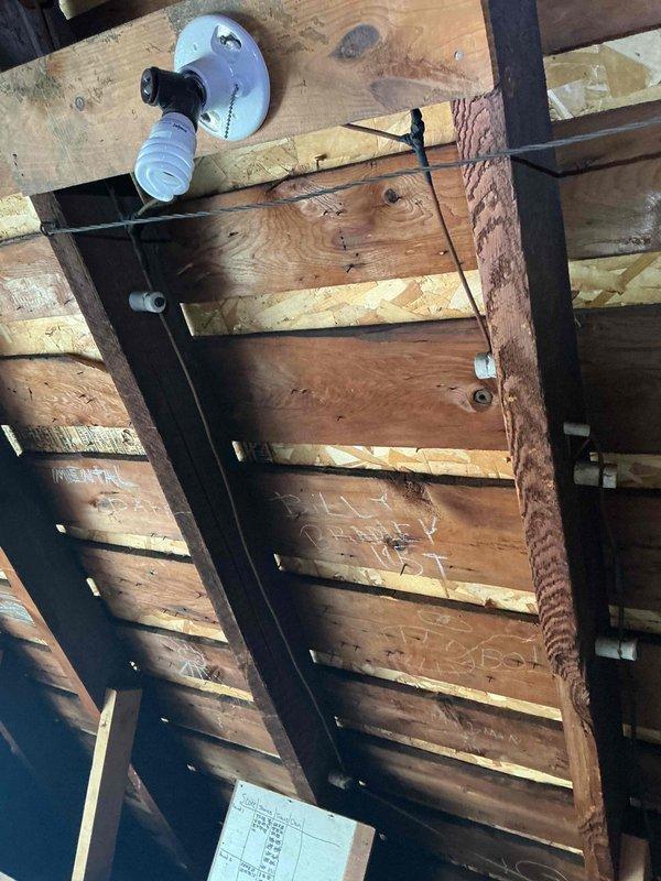 Responded to service request for electrical assessment in attic space. Upon arrival, conducted exterior inspection of existing electrical service and meter location to evaluate current capacity and available circuits for potential attic electrical addition. Proceeded to attic space and performed comprehensive evaluation of existing conditions, including structural layout, accessibility, and proximity to existing electrical distribution. Documented current wiring configuration, including visible Romex cable and ceiling-mounted electrical fixture with standard white porcelain socket. Assessed wooden joist structure and plywood decking to determine optimal routing path for new electrical service. Photographed existing electrical infrastructure both at exterior service entrance and within attic space to provide documentation for electrical load calculation and circuit planning. Evaluated feasibility of extending electrical service to attic area, considering code compliance requirements, pr