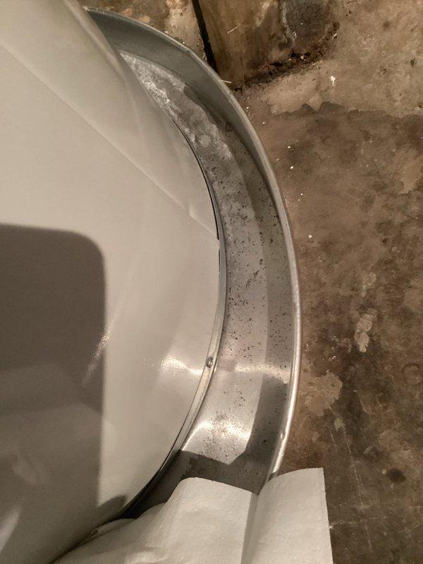 Responded to report of water accumulation in drain pan beneath two-year-old Bradford White water heater model WT 05-2030. Upon arrival, inspected unit and found active water presence in pan while heater continued to operate and produce hot water. Removed insulation jacket to access and examine temperature and pressure relief valve, drain valve, and supply line connections for signs of leakage. Conducted thorough visual inspection of all plumbing connections, fittings, and tank exterior to identify source of water discharge. Documented conditions with photographs showing valve assembly area and drain pan for warranty and service record purposes. Unit remains operational pending determination of leak source and recommended repairs.