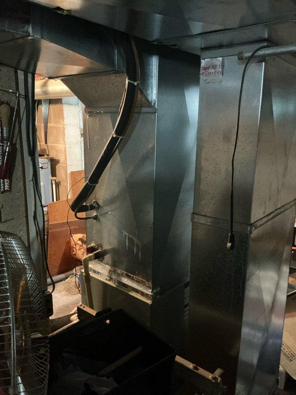 Completed estimate for non-operational air conditioning system in residential property. Inspected 20+ year old Trane HVAC system located in basement mechanical room, including furnace, air handler, and associated ductwork. Documented existing equipment configuration with metal supply ductwork, flexible return ducts, and PVC condensate drainage system. Assessed condition of aging unit and provided replacement options with available financing programs to address failed cooling system.