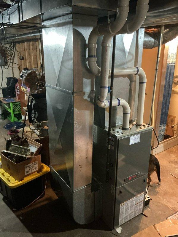 Completed estimate for non-operational air conditioning system in residential property. Inspected 20+ year old Trane HVAC system located in basement mechanical room, including furnace, air handler, and associated ductwork. Documented existing equipment configuration with metal supply ductwork, flexible return ducts, and PVC condensate drainage system. Assessed condition of aging unit and provided replacement options with available financing programs to address failed cooling system.