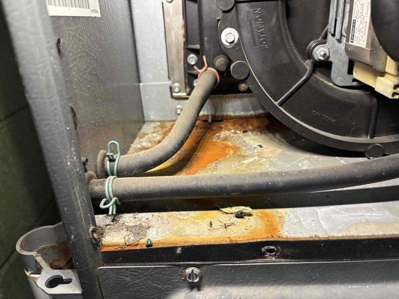 # AC Super Tune-Up Completed

Performed comprehensive AC Super Tune-up on residential cooling system. Conducted thorough inspection of all major components including evaporator coil, blower assembly, electrical connections, and capacitor. Verified proper operation of control board with multiple relays and confirmed all wire connections are secure with good insulation integrity. Noted significant rust and corrosion present on equipment base platform, though structural integrity remains intact and does not currently affect system operation. Cleaned accessible components, tested capacitor readings within acceptable range, and confirmed proper refrigerant line connections secured with appropriate fasteners. System operating normally upon completion with all safety checks passed.