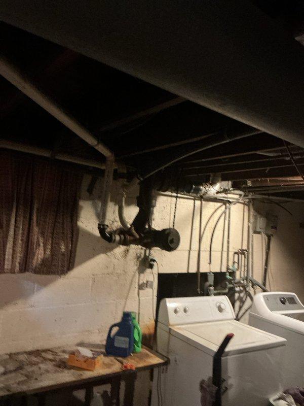 Responded to plumbing leak complaint with water intrusion into crawlspace originating from kitchen sink drain line. Upon inspection of basement and crawlspace area, located compromised drain pipe beneath kitchen sink with active leak occurring during fixture operation. Water had been infiltrating crawlspace for extended period, evidenced by musty odor that became noticeable with warmer temperatures. Audible water splashing confirmed when kitchen sink was operated. Accessed crawlspace through basement to assess damage extent and locate exact failure point. Documented conditions with photographs showing affected areas including crawlspace access point and basement utility area near laundry equipment. Leak isolated to drain line connection, with no secondary water damage visible in other areas of residence. Provided documentation of findings and repair recommendations to address failed pipe section and prevent continued water intrusion into crawlspace.