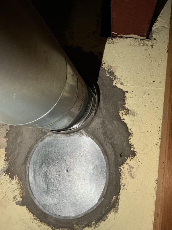 Responded to water heater leak complaint and found a 25+ year old residential water heater with a slight trickle leak in basement utility room. Upon inspection, documented the aging unit with multiple deteriorated components and evidence of moisture on the concrete floor near the base. Given the advanced age of the equipment (exceeding typical 10-15 year lifespan) and active leak condition, recommended complete water heater replacement to prevent potential flooding and property damage.