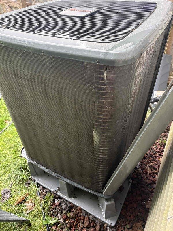 Completed annual cooling system tune-up and furnace maintenance on residential HVAC system. Performed comprehensive inspection of indoor furnace unit with integrated Honeywell Home humidifier and outdoor condensing unit. Inspected all electrical connections, ductwork, condensate drain lines, and system controls. Noted exterior coil surfaces on outdoor unit showing accumulation of dirt, pollen, and debris on protective mesh screening with visible moisture streaking. Verified proper operation of all system components and confirmed unit functionality for continued seasonal use.