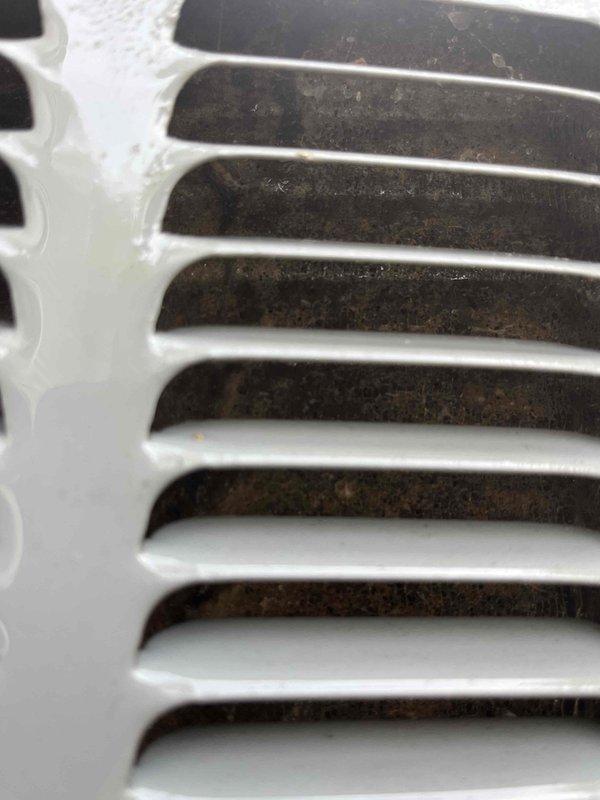 Completed annual cooling system maintenance on EnergiAir unit under active warranty coverage. Performed comprehensive inspection of evaporator coil assembly, noting minor dust accumulation on fin surfaces but overall satisfactory heat exchange component condition. Inspected return air grille and documented moderate dust and debris buildup between louvers and in recessed areas, typical of normal system operation. All photographic documentation captured for warranty and maintenance records.