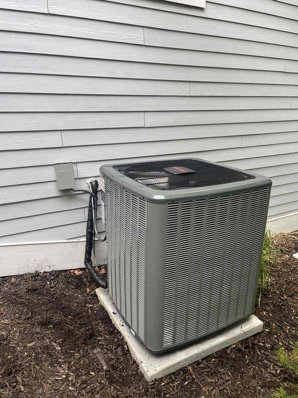 Completed full air conditioning system replacement including outdoor condensing unit and indoor air handler/furnace components. Installed new equipment in basement utility area with proper PVC drainage lines, electrical connections, and ductwork integration. Positioned outdoor unit on concrete pad with appropriate clearances, connected refrigerant lines, and verified all electrical disconnects and controls are properly installed and operational.