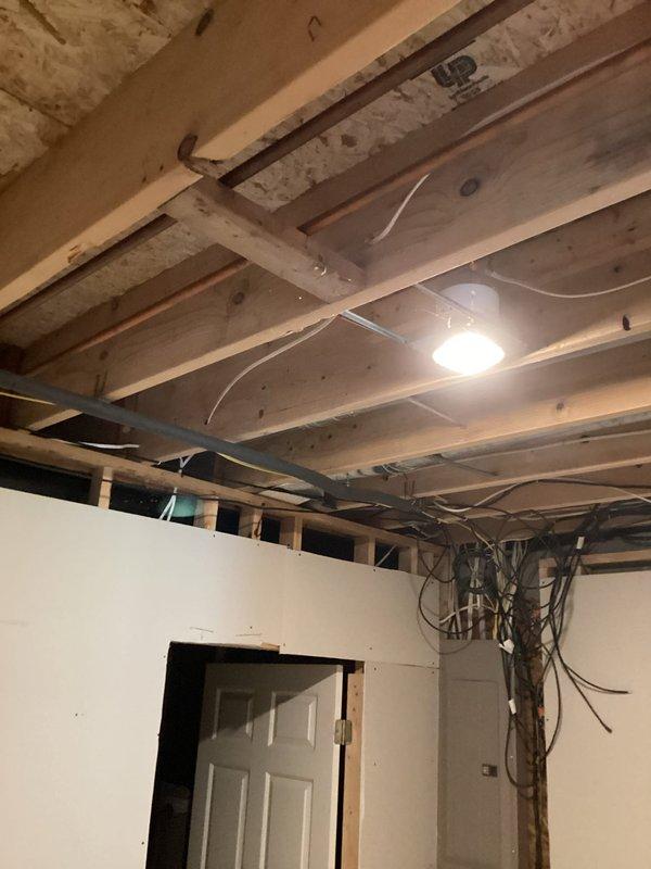 Conducted electrical estimate for installation of 220-volt circuit in residential property. Assessed unfinished basement area with exposed ceiling joists and partial drywall installation to determine optimal routing for new dedicated circuit. Documented existing electrical infrastructure, including current wiring configuration and available panel capacity, to provide accurate scope of work for high-voltage appliance connection.